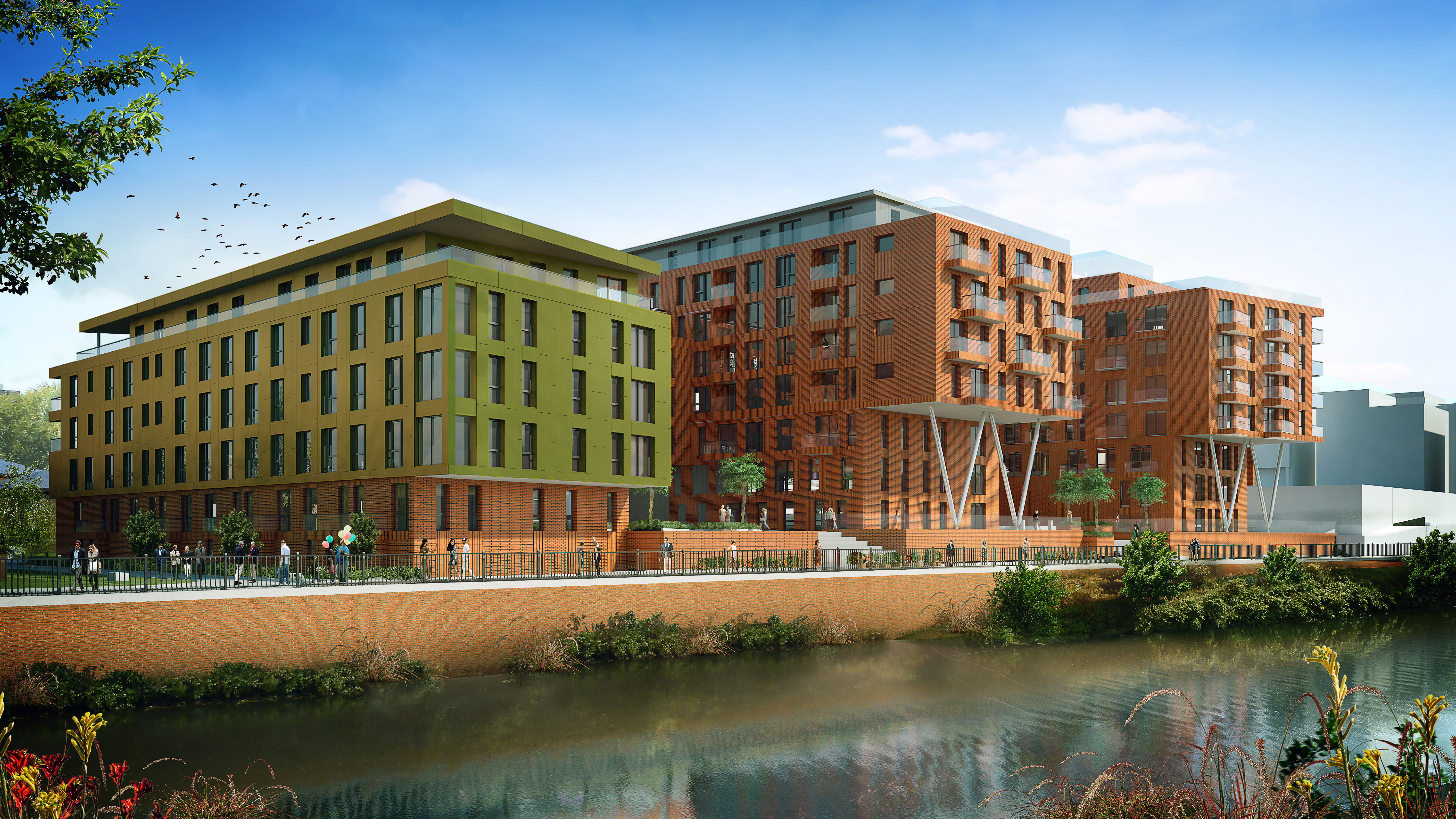 view across a canal of 3 sections of a residential red brick building